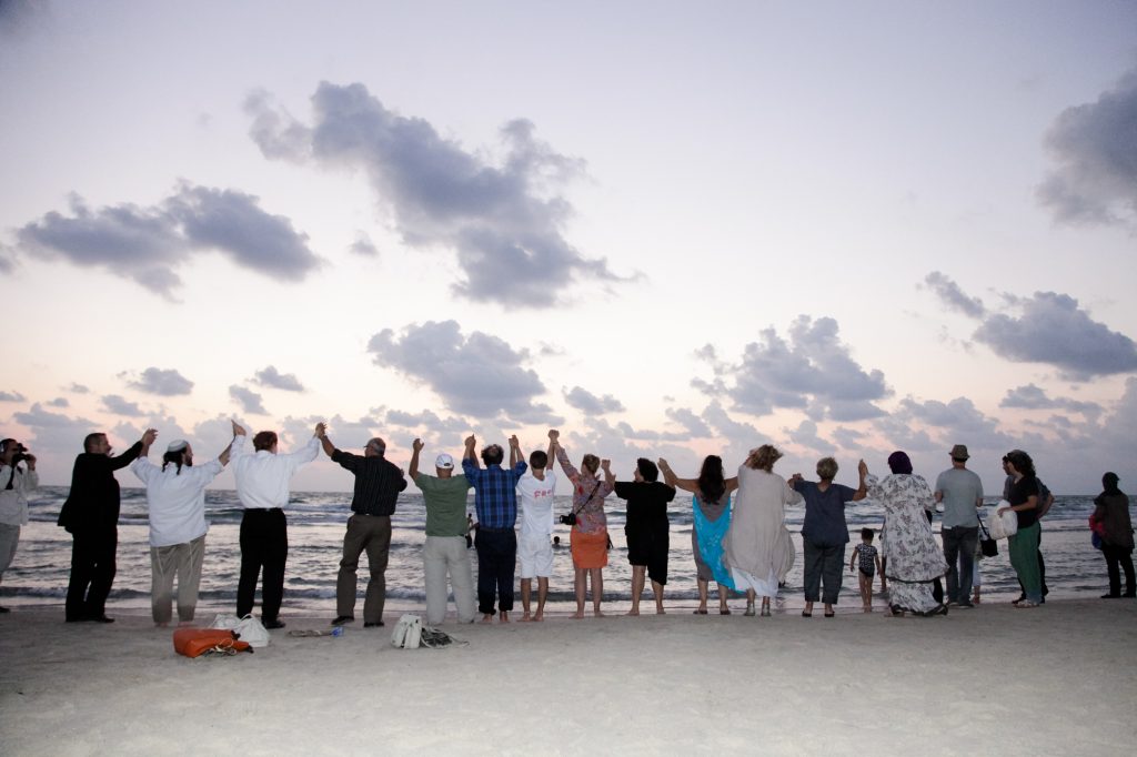 Holding hands together at the Jisr az-Zarka beach, south of Haifa.